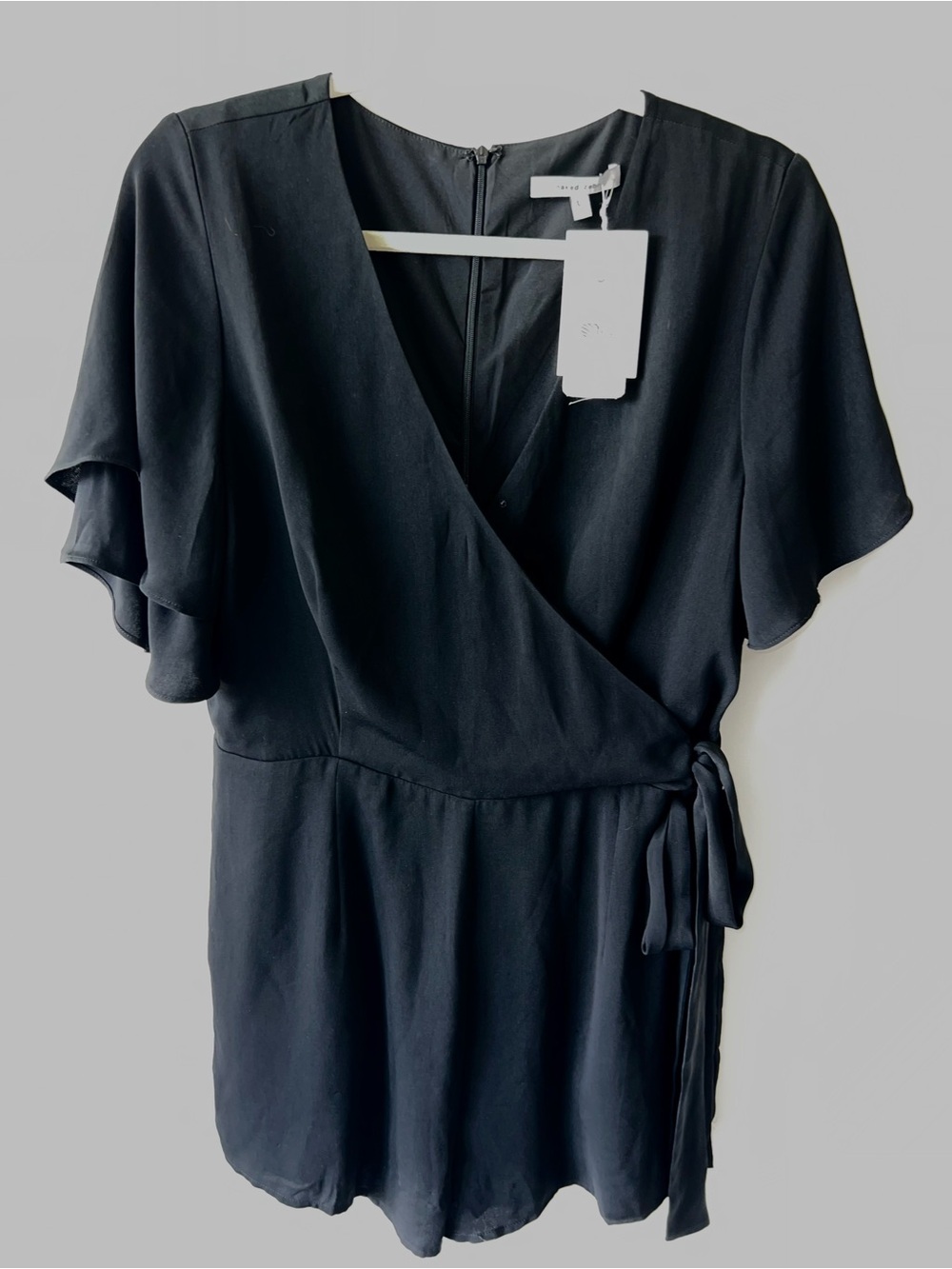 NWT Naked Zebra Black Faux Wrap Romper with Flutter Sleeves and Tie Waist